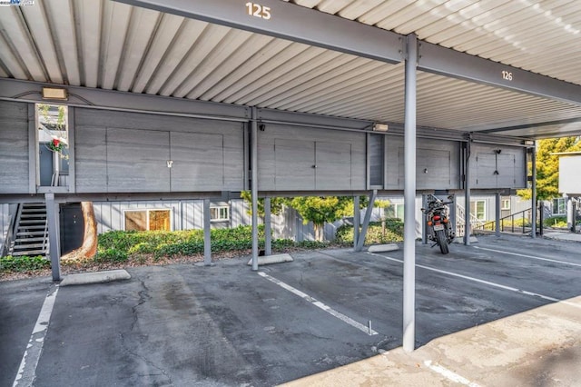 view of parking / parking lot featuring a carport