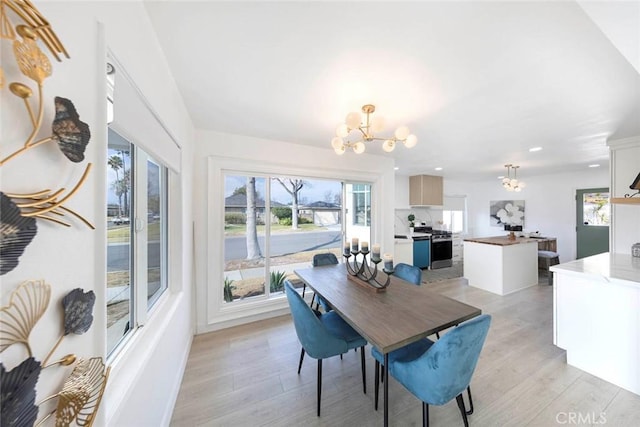 dining space featuring a chandelier and light wood finished floors