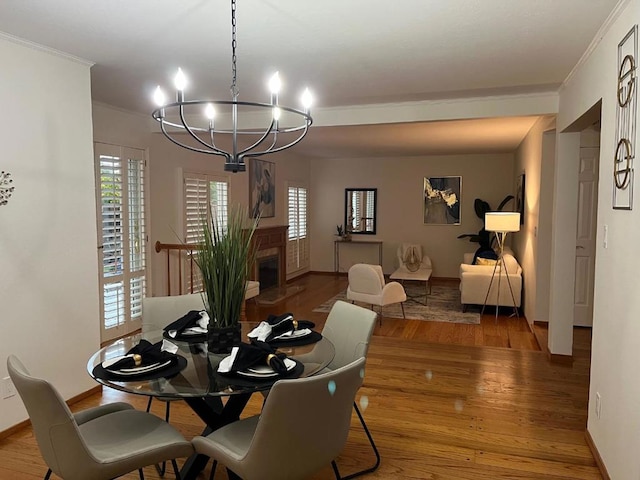 dining space with crown molding, hardwood / wood-style flooring, and a chandelier