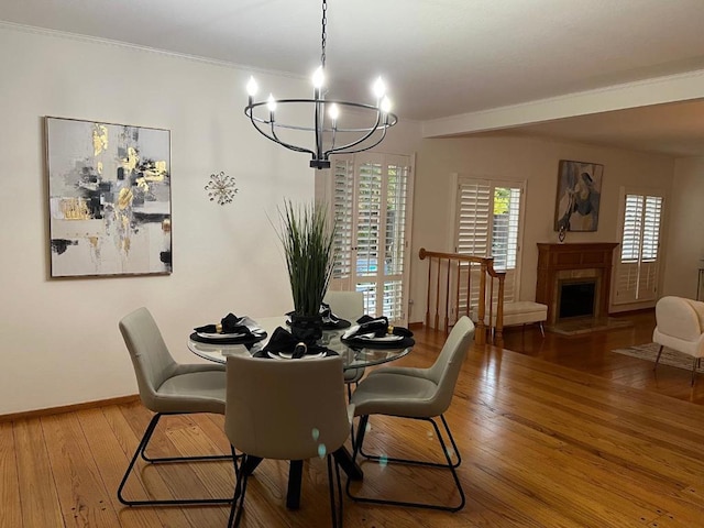 dining area featuring hardwood / wood-style flooring and an inviting chandelier