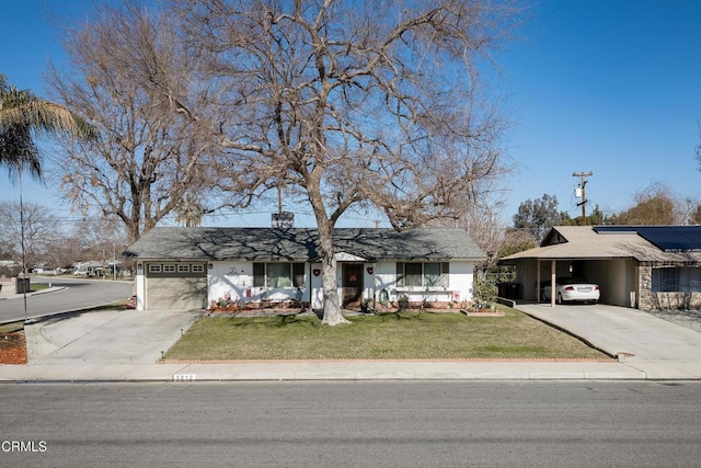 single story home with concrete driveway, a garage, a carport, and a front yard