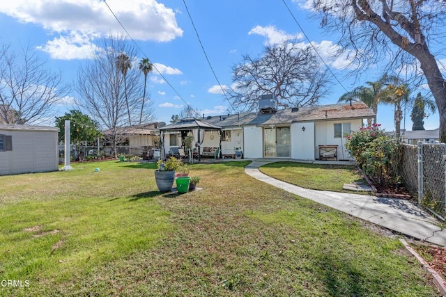 back of house featuring a gazebo, a patio area, a lawn, and fence