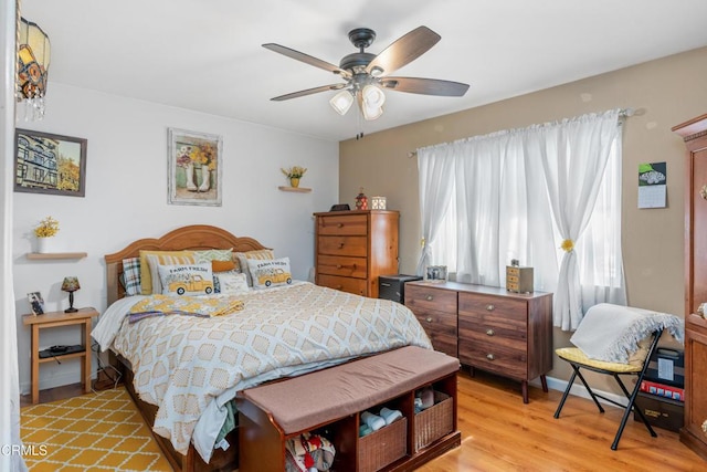 bedroom with light wood-style flooring and a ceiling fan