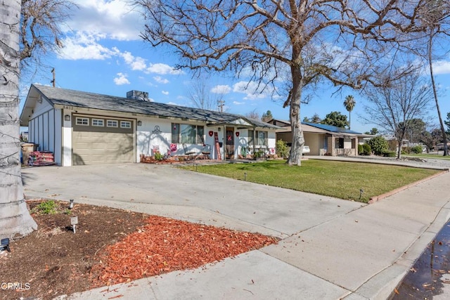 single story home with a garage, concrete driveway, and a front lawn