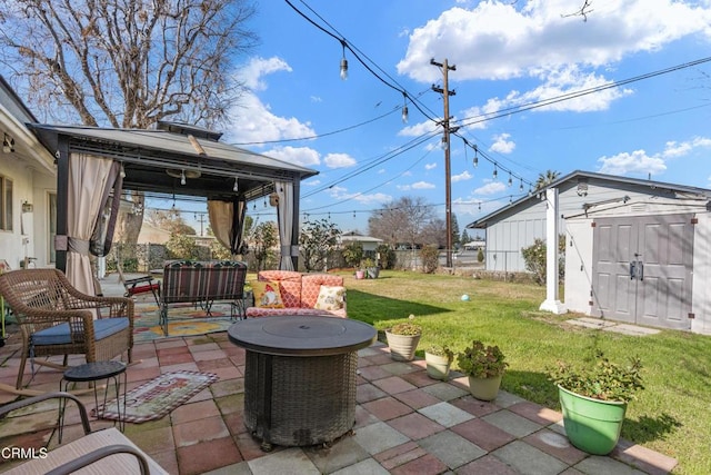 view of patio with a gazebo, an outbuilding, outdoor lounge area, and a shed