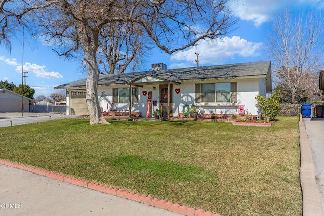 single story home featuring a front lawn, an attached garage, driveway, and stucco siding