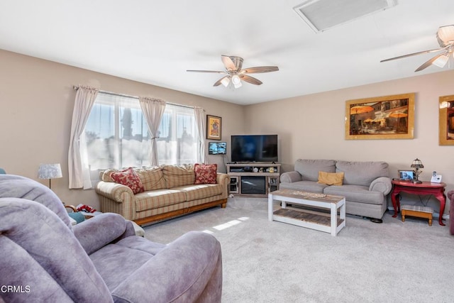 living room with visible vents, carpet floors, and a ceiling fan