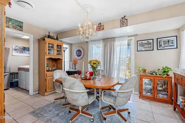 dining space with an inviting chandelier and light tile patterned floors