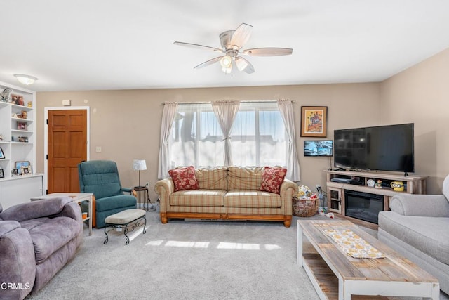 carpeted living area featuring ceiling fan