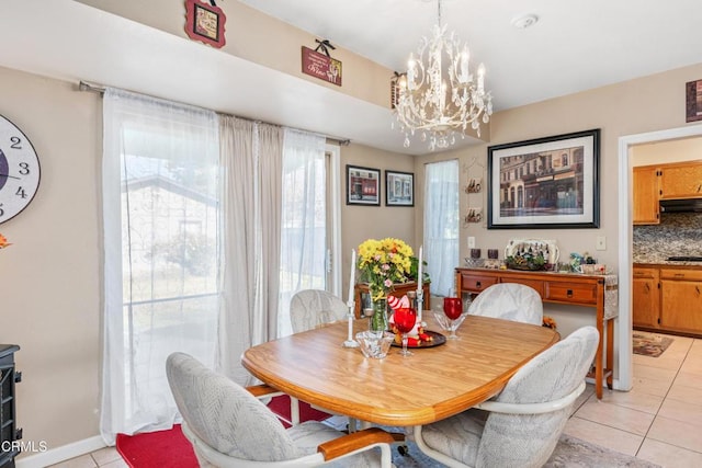 dining room with light tile patterned flooring and an inviting chandelier