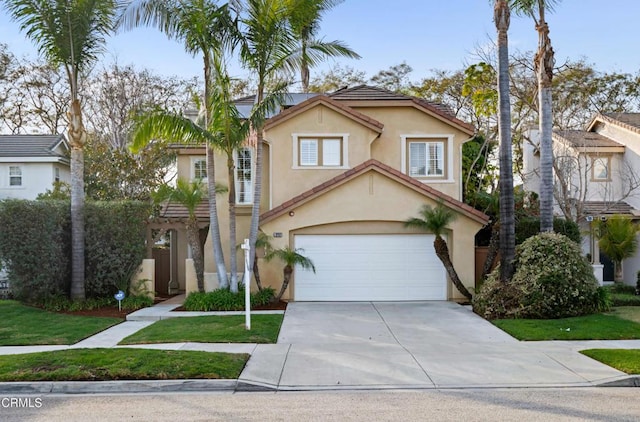 view of front facade with a garage and a front yard