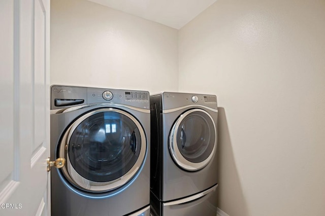 clothes washing area featuring separate washer and dryer