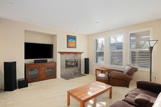 living room with light colored carpet and a tile fireplace