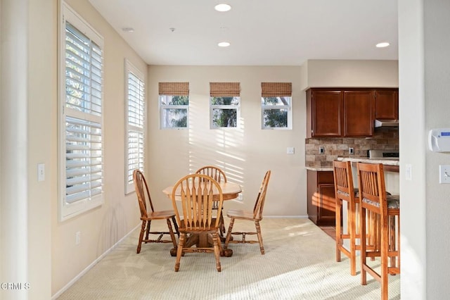 dining room with light carpet and a wealth of natural light