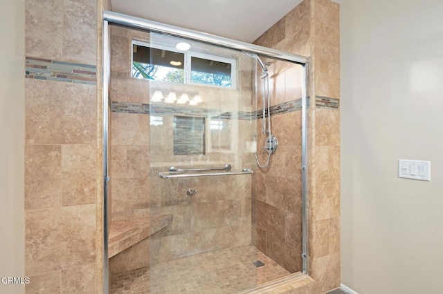 bathroom featuring a shower with door