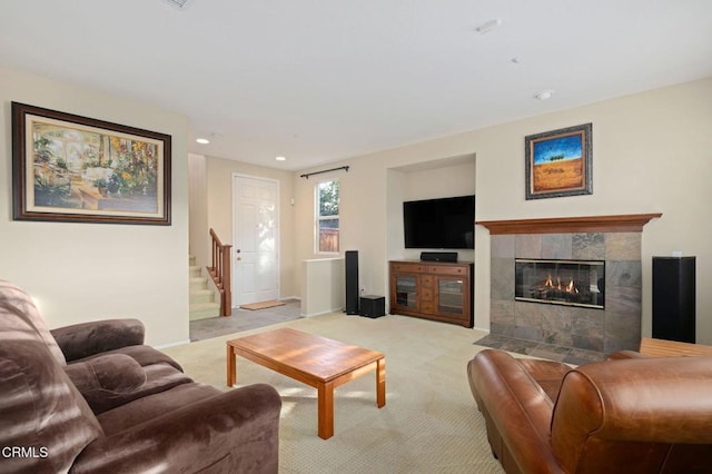 carpeted living room with a tiled fireplace