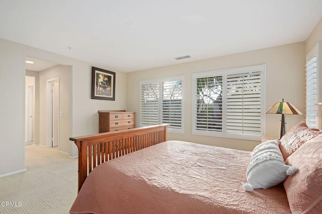 bedroom featuring light carpet