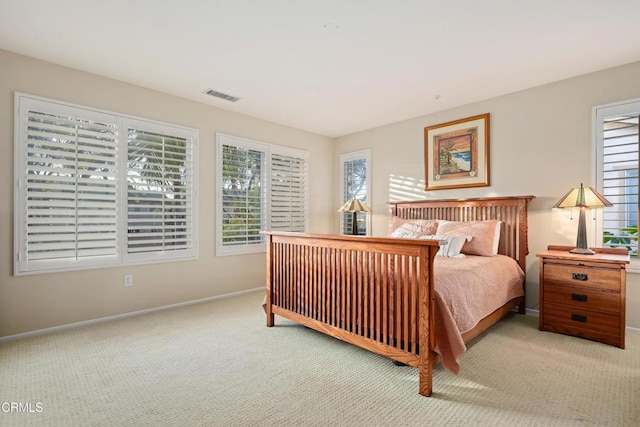 bedroom featuring light colored carpet