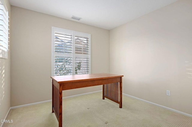 unfurnished office featuring light colored carpet