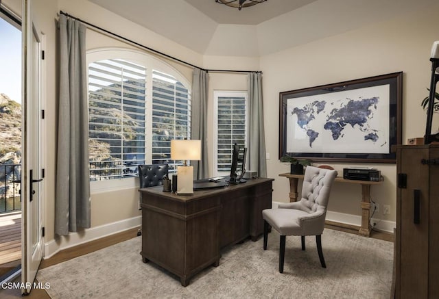 home office with light hardwood / wood-style floors