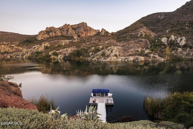 property view of water featuring a mountain view and a boat dock