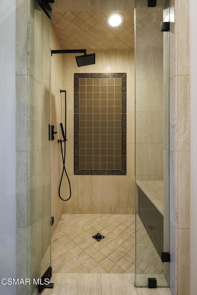 bathroom featuring a shower with shower door