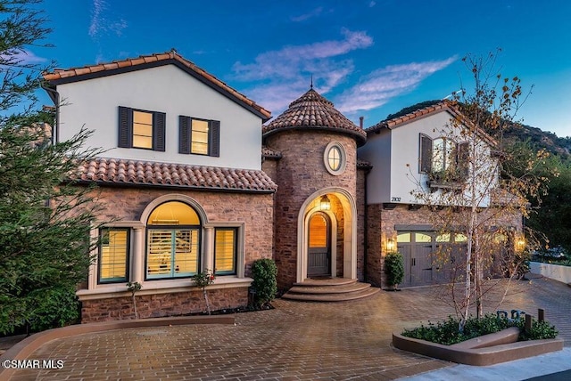 mediterranean / spanish house featuring a garage