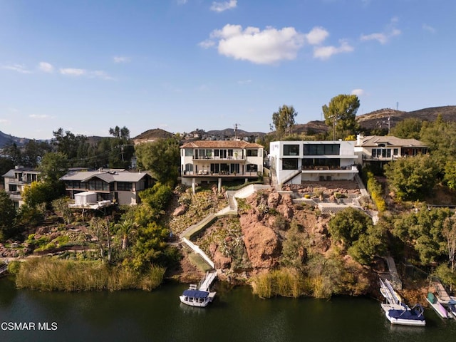 birds eye view of property featuring a water and mountain view