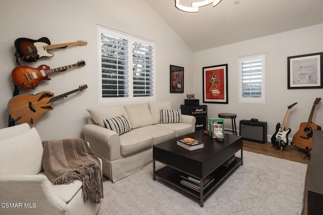 living room with vaulted ceiling and light hardwood / wood-style flooring