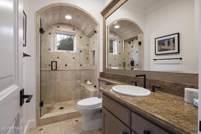 bathroom with tile patterned floors, toilet, ornamental molding, vanity, and a shower with door