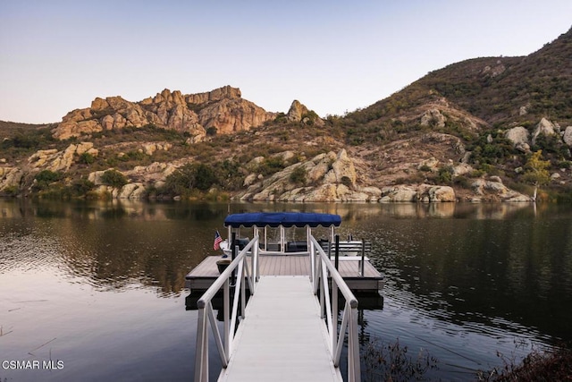 view of dock with a water and mountain view