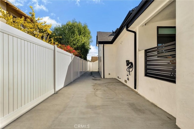 exterior space with stucco siding, fence, and a patio