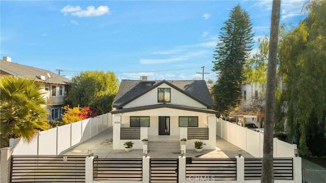 view of front of home featuring a patio area, a fenced front yard, and stucco siding