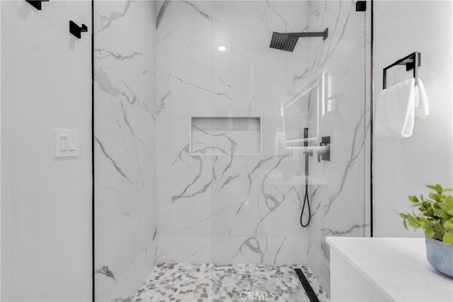 full bathroom with a marble finish shower