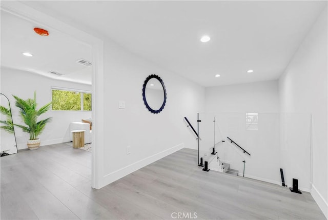 exercise area with recessed lighting, visible vents, baseboards, and wood finished floors