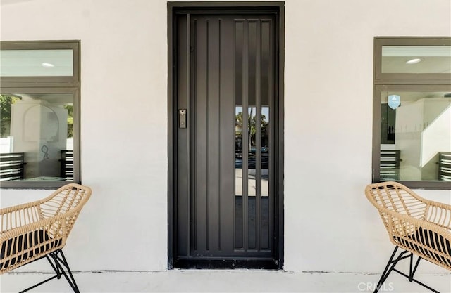 view of exterior entry with stucco siding