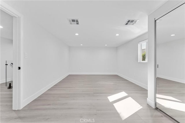 basement featuring recessed lighting, visible vents, light wood-style flooring, and baseboards