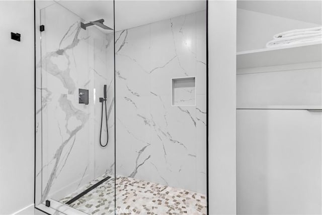 bathroom with a marble finish shower