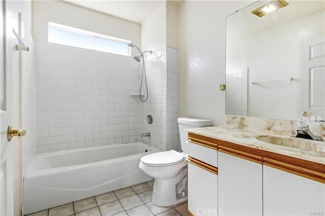 full bathroom featuring tiled shower / bath combo, vanity, tile patterned floors, and toilet