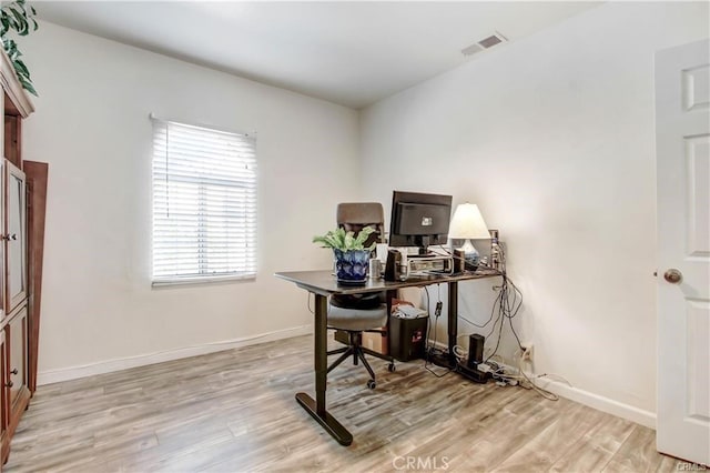 office space with light wood-type flooring