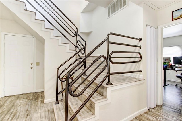 staircase featuring wood-type flooring