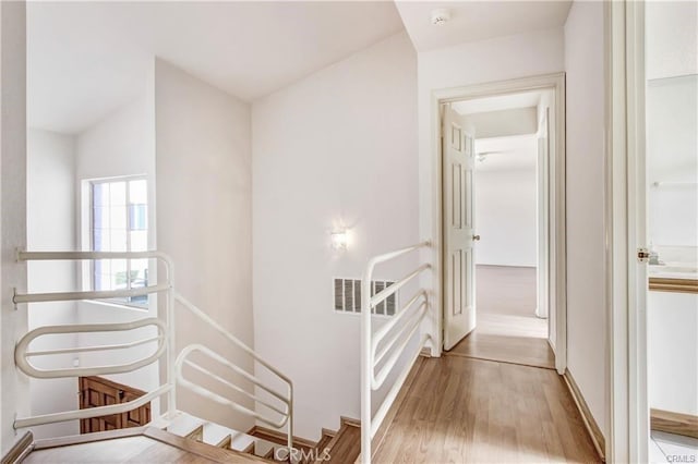 hallway with light hardwood / wood-style flooring