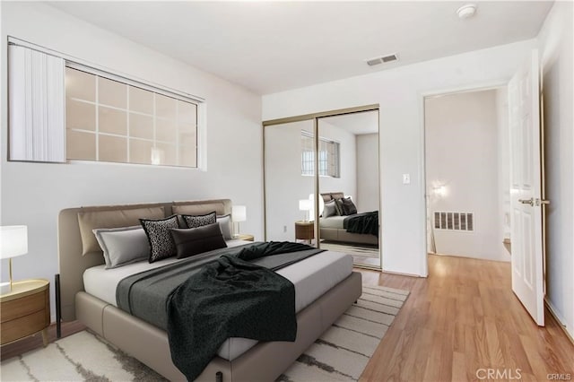 bedroom featuring a closet and light hardwood / wood-style flooring