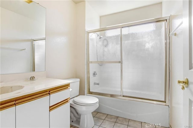 full bathroom with tile patterned flooring, vanity, shower / bath combination with glass door, and toilet