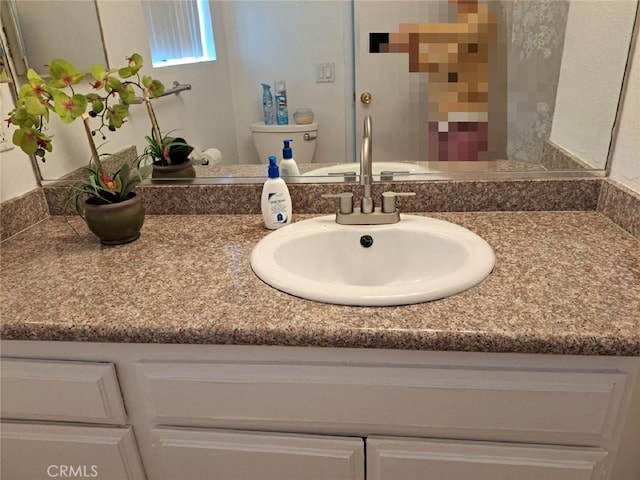 bathroom featuring vanity and toilet