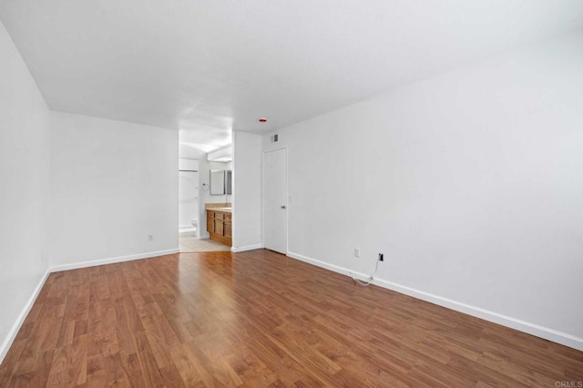 unfurnished living room with wood-type flooring