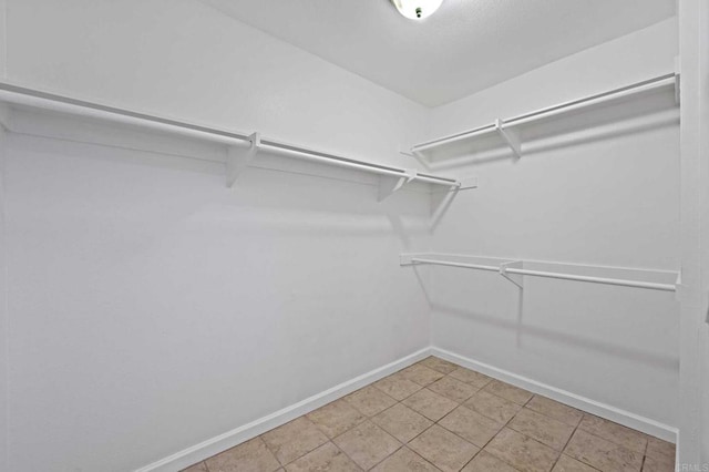 spacious closet with tile patterned floors