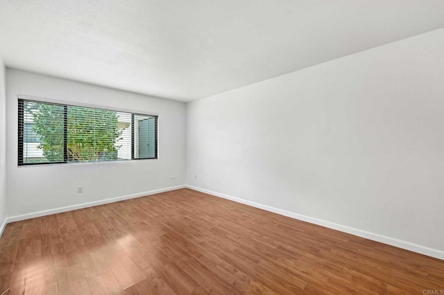 spare room with wood-type flooring