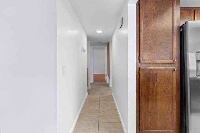 hall featuring light tile patterned floors