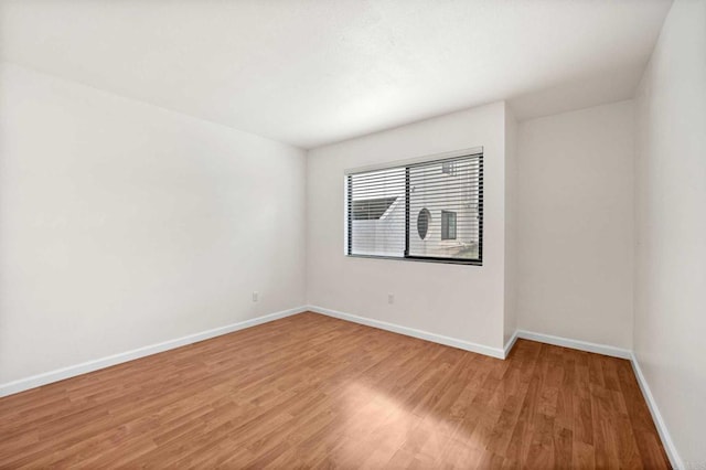 empty room with hardwood / wood-style flooring